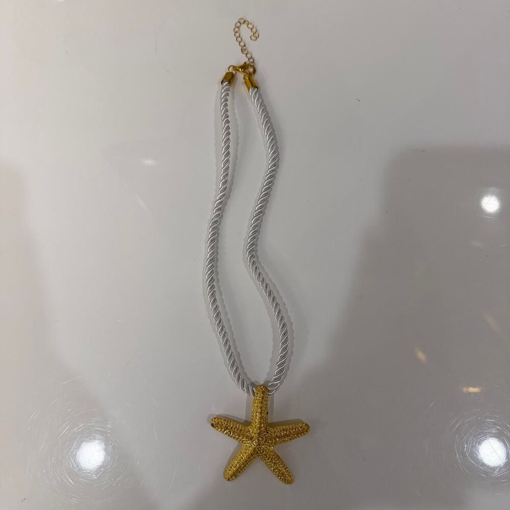gold starfish pendant white cord necklace